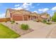 Charming two-story home with a large driveway, three-car garage, and inviting front porch at 1100 Columbine Way, Erie, CO 80516