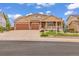 Lovely home exterior with a three-car garage, covered front porch, a well-kept lawn, and attractive landscaping at 1100 Columbine Way, Erie, CO 80516