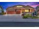 Inviting front exterior with a well-manicured lawn, a three-car garage, covered porch, and warm exterior paint colors at 1100 Columbine Way, Erie, CO 80516