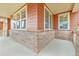 Inviting porch with brick accents and elegant columns that provide a welcoming entry to the home at 1100 Columbine Way, Erie, CO 80516