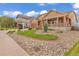 Charming home with manicured front yard, rock landscaping, and 'For Sale' sign at 1100 Columbine Way, Erie, CO 80516