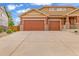Spacious three car garage features traditional doors, brick accents and driveway with lots of parking space at 1100 Columbine Way, Erie, CO 80516