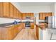 Traditional kitchen featuring wood cabinets, granite countertops, and stainless steel appliances at 1100 Columbine Way, Erie, CO 80516