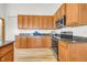 Kitchen with wood cabinetry, and modern stainless steel appliances at 1100 Columbine Way, Erie, CO 80516