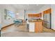 Open concept kitchen and dining area featuring wood cabinetry, center island, and breakfast bar at 1100 Columbine Way, Erie, CO 80516