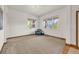 Bright living room with chair, chandelier, and large windows offering plenty of natural light at 1100 Columbine Way, Erie, CO 80516