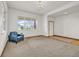 Comfortable living room featuring carpet, natural light, and a bright white door at 1100 Columbine Way, Erie, CO 80516