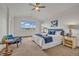 Airy main bedroom featuring large windows with scenic views, a tray ceiling, and coordinated decor in soft, calming colors at 1100 Columbine Way, Erie, CO 80516