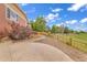 The home boasts a beautiful side yard, featuring a curved walkway and meticulously arranged landscaping with rock and natural wood accents at 1100 Columbine Way, Erie, CO 80516