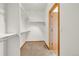 The walk-in closet is spacious with shelving ready to be filled with your clothes and accessories at 1100 Columbine Way, Erie, CO 80516