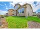 A house featuring a well-maintained green lawn, large windows, and complementary landscaping at 6335 E 143Rd Dr, Thornton, CO 80602
