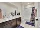 Bathroom with double sinks, shower over tub, and neutral colors at 6335 E 143Rd Dr, Thornton, CO 80602
