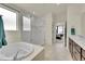 This bathroom has double sinks, separate tub, and tiled shower stall at 6335 E 143Rd Dr, Thornton, CO 80602