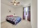 This bedroom includes plush carpet, fan, and a window at 6335 E 143Rd Dr, Thornton, CO 80602