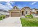 Charming two-story home with a well-manicured lawn and inviting stone accents at 6335 E 143Rd Dr, Thornton, CO 80602
