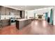 Modern kitchen with dark cabinetry, granite counters, and an open layout to the living area at 6335 E 143Rd Dr, Thornton, CO 80602