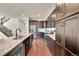 Gourmet kitchen boasting dark cabinets, stainless steel appliances, and a large center island at 6335 E 143Rd Dr, Thornton, CO 80602