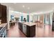 Open concept living space featuring a modern kitchen, dining area, and cozy living room with fireplace at 6335 E 143Rd Dr, Thornton, CO 80602