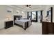 This main bedroom has neutral carpet, fan, and many windows at 6335 E 143Rd Dr, Thornton, CO 80602