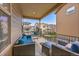 Covered patio with comfortable seating, hanging chair, and neighborhood view at 6335 E 143Rd Dr, Thornton, CO 80602