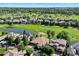 Aerial view of a community, highlighting lush landscaping, golf course, and surrounding neighborhood at 9151 E Harvard Ave, Denver, CO 80231
