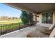 Relaxing back patio featuring stone pillars, cushioned lounge chairs, and a lovely view of the golf course at 9151 E Harvard Ave, Denver, CO 80231
