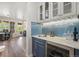 Convenient bar area with blue backsplash and wine fridge adjacent to dining area at 9151 E Harvard Ave, Denver, CO 80231