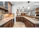 Basement bar with custom wood cabinets and counters, tile backsplash, and stainless appliances at 9151 E Harvard Ave, Denver, CO 80231