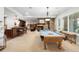 Basement with a pool table, fireplace, bar, and comfortable seating areas at 9151 E Harvard Ave, Denver, CO 80231