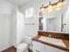 Bathroom featuring a single vanity, framed mirror, bronze accents, and white cabinetry at 9151 E Harvard Ave, Denver, CO 80231