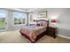 Comfortable bedroom with large windows and a view of a private yard at 9151 E Harvard Ave, Denver, CO 80231