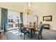 Elegant dining room with high ceilings, a large table, and double doors to the backyard at 9151 E Harvard Ave, Denver, CO 80231