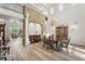 Elegant dining room with stone accent wall and large chandelier at 9151 E Harvard Ave, Denver, CO 80231