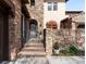 View of the home's entryway with stone facade and landscaped surroundings at 9151 E Harvard Ave, Denver, CO 80231