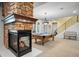 Entertain in this game room featuring a billiards table and cozy fireplace with stone surround at 9151 E Harvard Ave, Denver, CO 80231