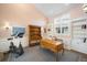 This home office features a classic wooden desk, exercise bike, and bright natural light at 9151 E Harvard Ave, Denver, CO 80231