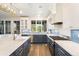 Gourmet kitchen features modern appliances, blue cabinetry, and granite countertops at 9151 E Harvard Ave, Denver, CO 80231