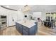 Bright kitchen with a large white island, stainless steel appliances, and an open layout leading to the living area at 9151 E Harvard Ave, Denver, CO 80231