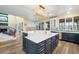 Spacious kitchen with blue cabinetry, white countertops and modern gold hardware at 9151 E Harvard Ave, Denver, CO 80231