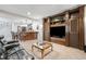 Entertainment center and bar create an inviting space in this carpeted living room at 9151 E Harvard Ave, Denver, CO 80231