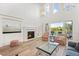 Cozy living room with a fireplace and views of the backyard at 9151 E Harvard Ave, Denver, CO 80231
