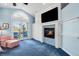 Comfortable main bedroom has an electric fireplace, television, and backyard access at 9151 E Harvard Ave, Denver, CO 80231