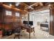 Wood paneled office space featuring a tray ceiling, built-ins, and a glass-enclosed mezzanine, perfect for remote work at 9151 E Harvard Ave, Denver, CO 80231