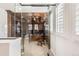 A wood-paneled office with glass doors features a desk and built-in bookcases at 9151 E Harvard Ave, Denver, CO 80231