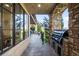 Covered outdoor patio featuring a built-in grill, stone columns, and an entertaining area with views of the backyard at 9151 E Harvard Ave, Denver, CO 80231