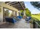 Inviting outdoor patio with comfortable seating, a pergola, and beautiful landscaping overlooking the golf course at 9151 E Harvard Ave, Denver, CO 80231