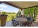 Covered patio boasts a table and chairs overlooking the community golf course at 9151 E Harvard Ave, Denver, CO 80231