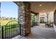 Covered patio with stone columns overlooking a golf course at 9151 E Harvard Ave, Denver, CO 80231