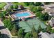 Aerial view of community pool and tennis courts, surrounded by lush greenery and manicured grounds at 9151 E Harvard Ave, Denver, CO 80231