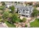 Aerial view of a spacious home, mature trees, landscaped yard, large deck, and covered patio at 1199 Links Ct, Erie, CO 80516